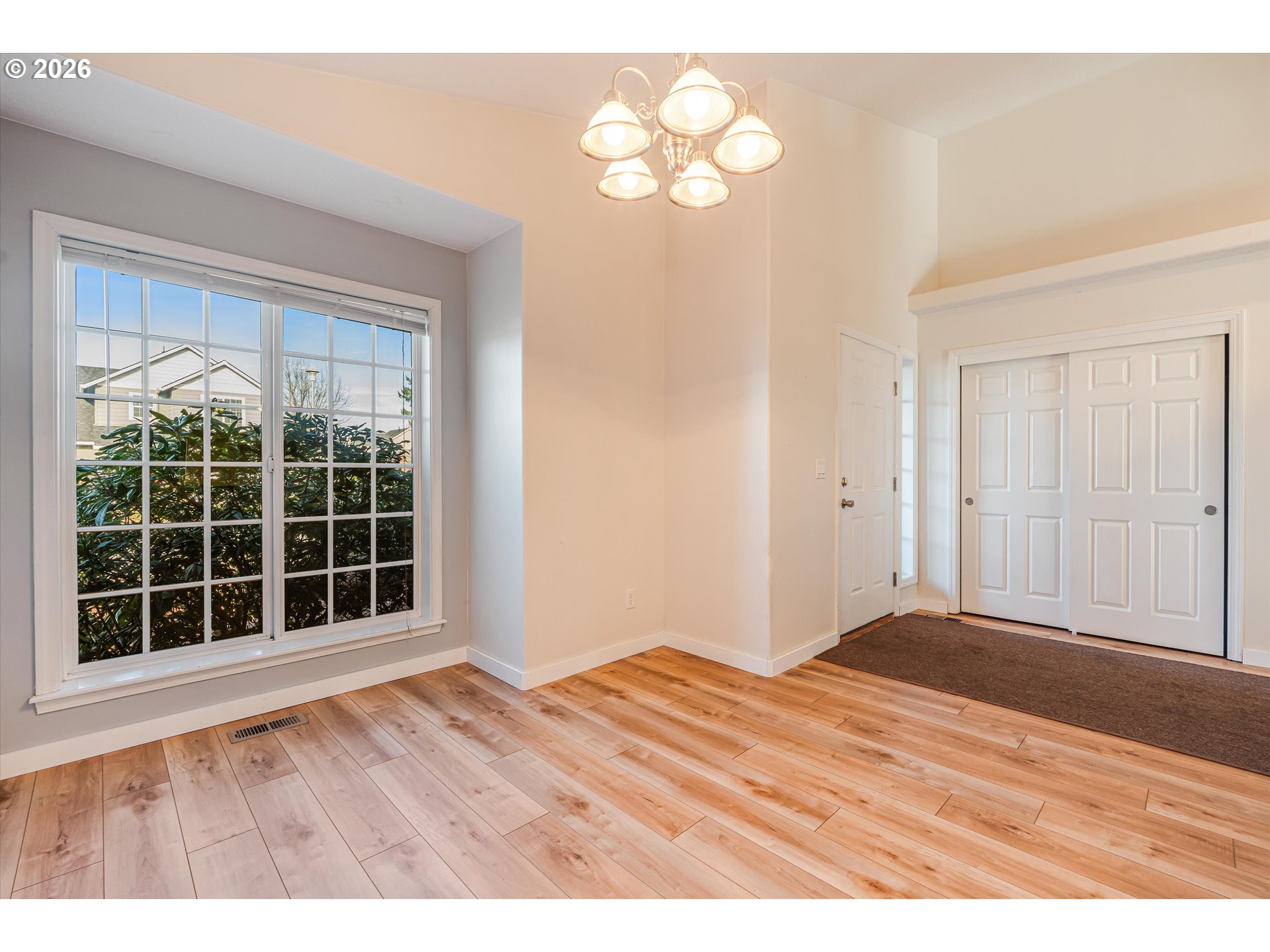 1407 Southeast 7th Avenue Canby, OR 97013 - Photo 8 of 31 a view of an empty room with wooden floor and windows
