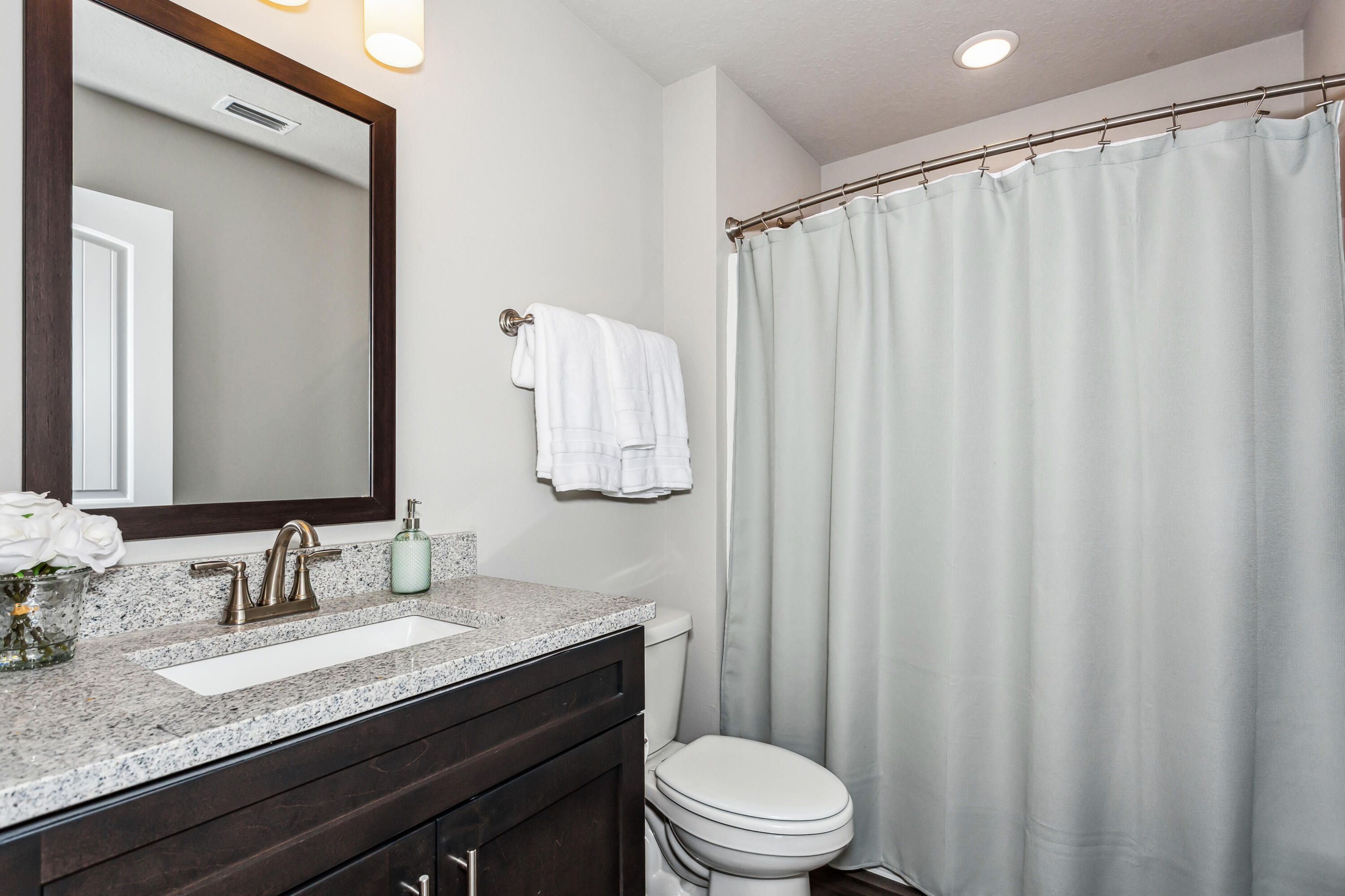 4769 Horace Lunsford Road Milton, FL 32570 - Photo 20 of 21 a bathroom with a granite countertop sink and a mirror