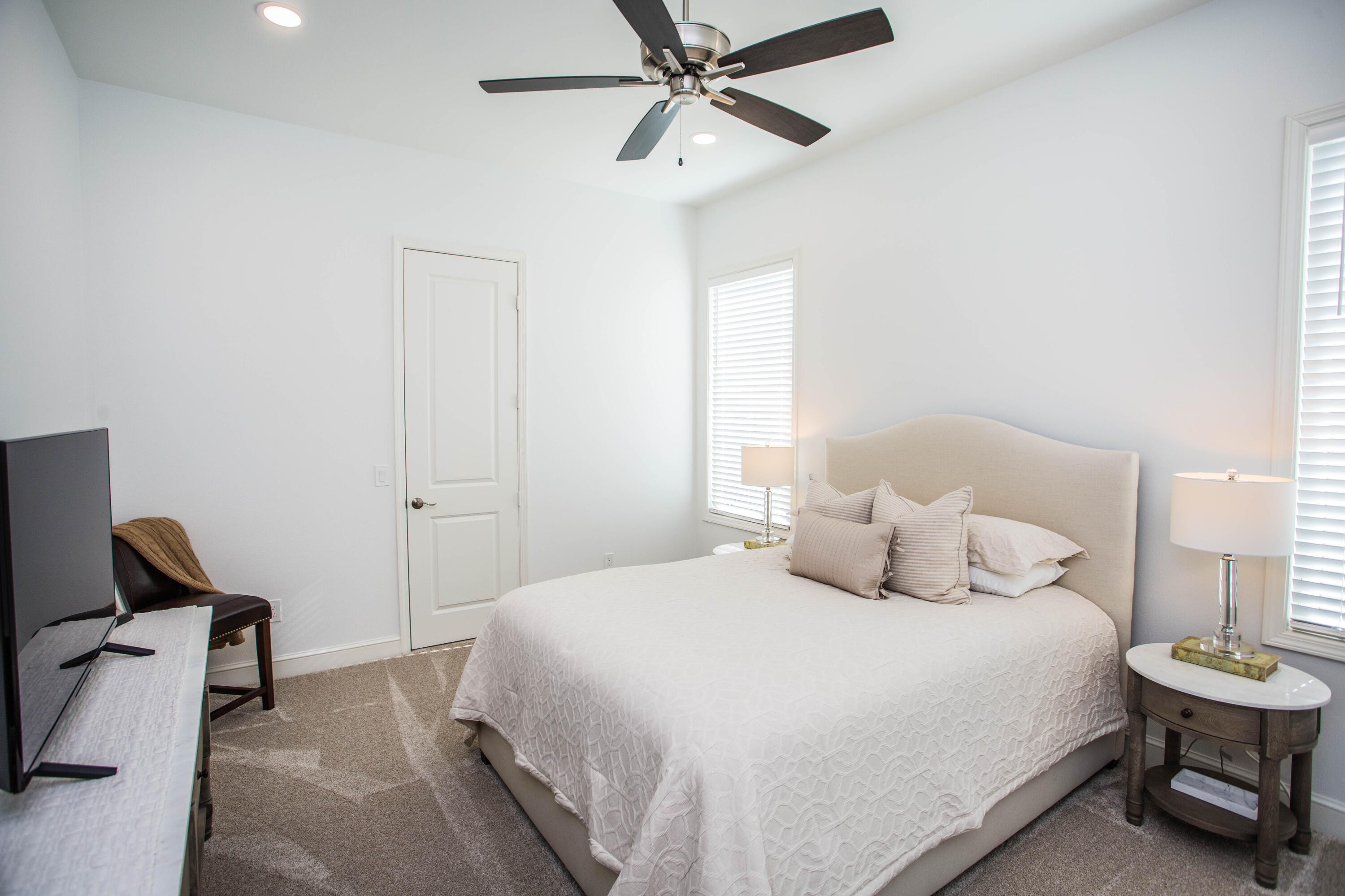 209 South Holliday Plainview, TX 79072 - Photo 16 of 29 a bedroom with a bed and a chandelier
