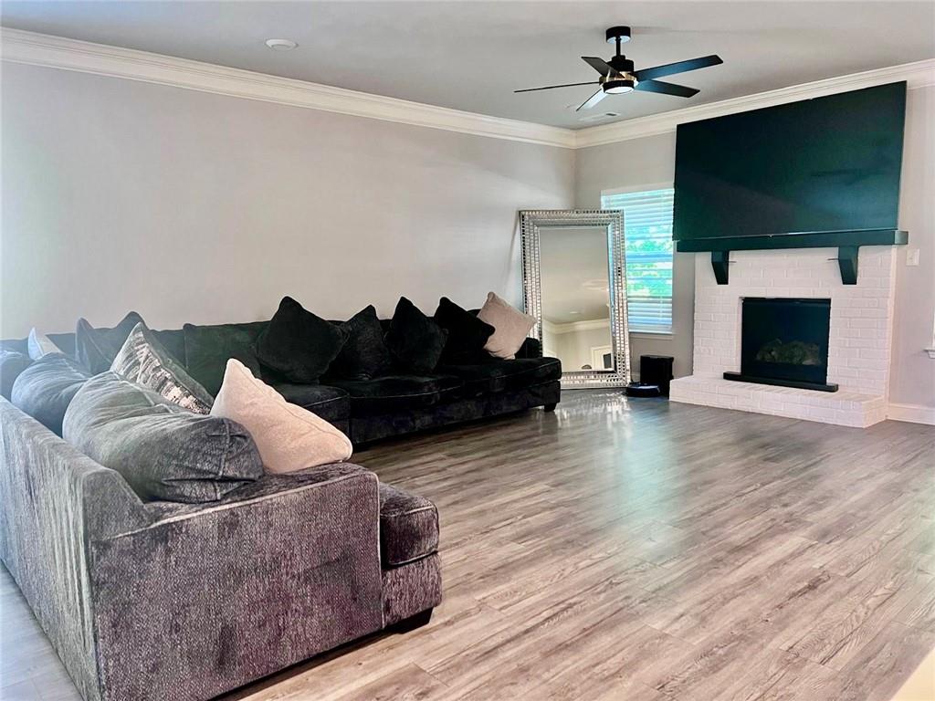 3370 Elkhorn Ridge Run Dacula, GA 30019 - Photo 11 of 29 a living room with furniture a flat screen tv and a fireplace
