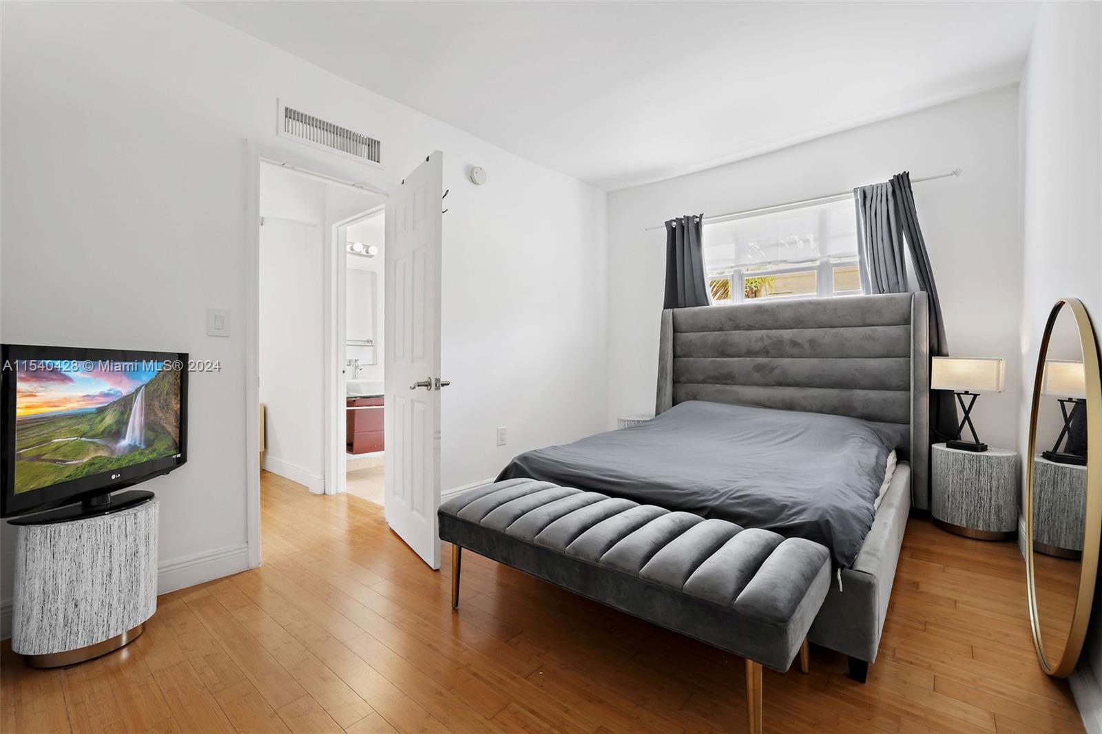 4812 Pine Tree Drive, Unit 207 Miami Beach, FL 33140 - Photo 12 of 23 a bedroom with furniture and a flat screen tv