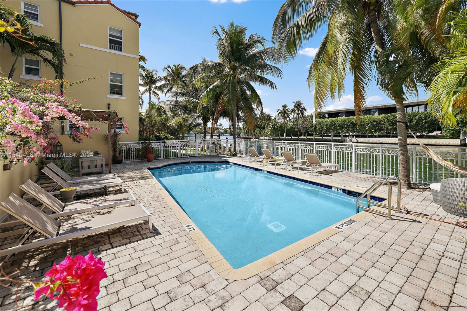 4812 Pine Tree Drive, Unit 207 Miami Beach, FL 33140 - Photo 17 of 23 a view of a swimming pool with a lounge chairs