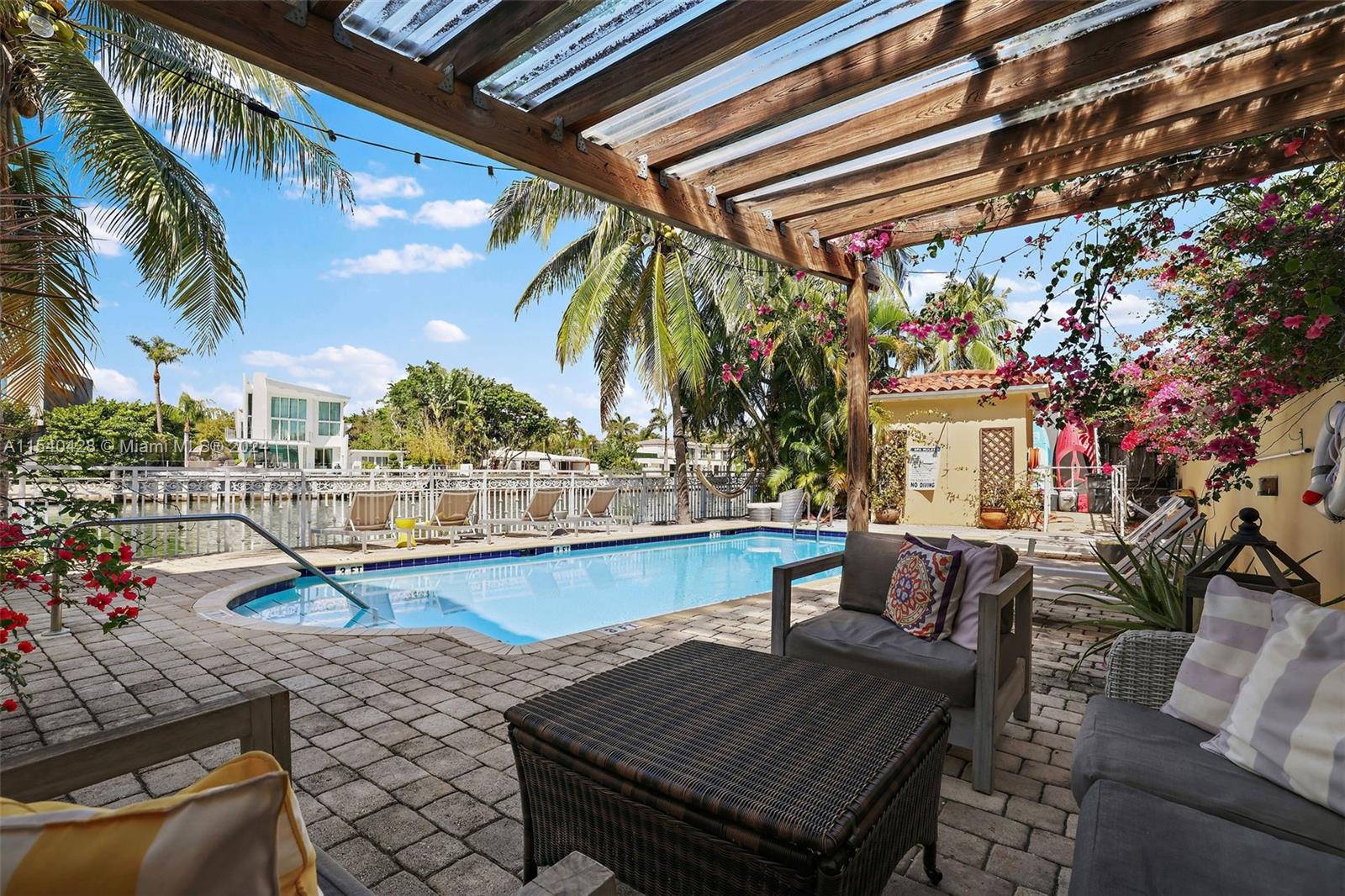 4812 Pine Tree Drive, Unit 207 Miami Beach, FL 33140 - Photo 18 of 23 a view of a chairs and table in the patio