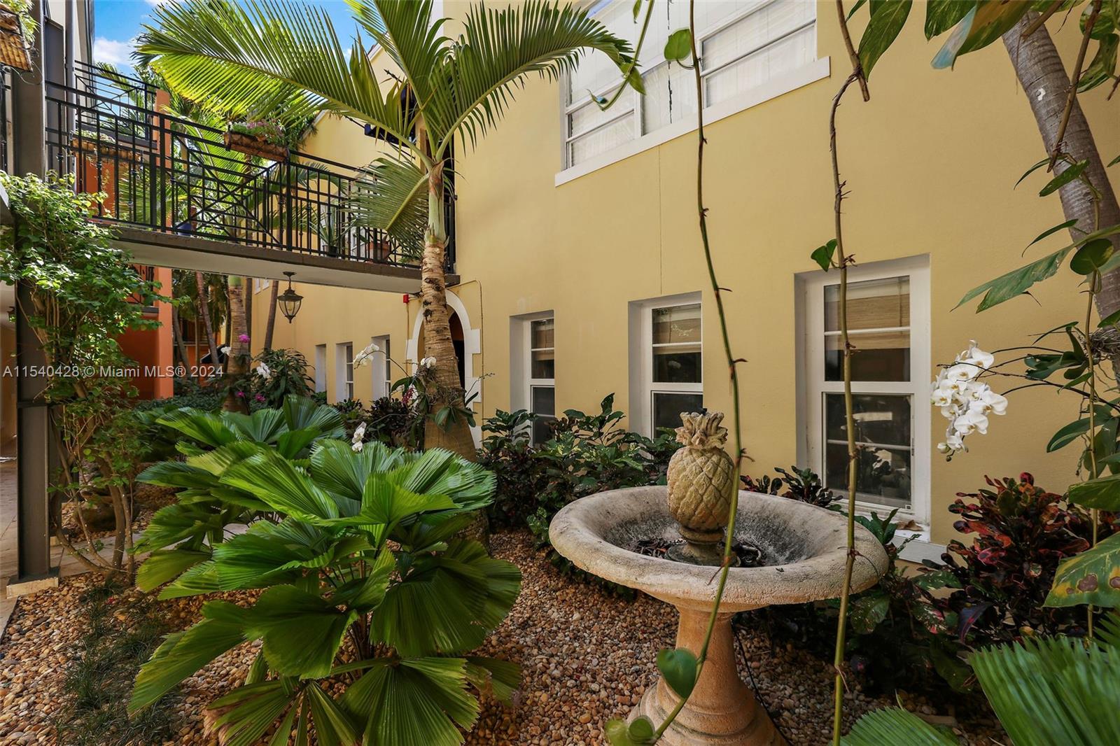 4812 Pine Tree Drive, Unit 207 Miami Beach, FL 33140 - Photo 19 of 23 a view of a backyard with plants and patio