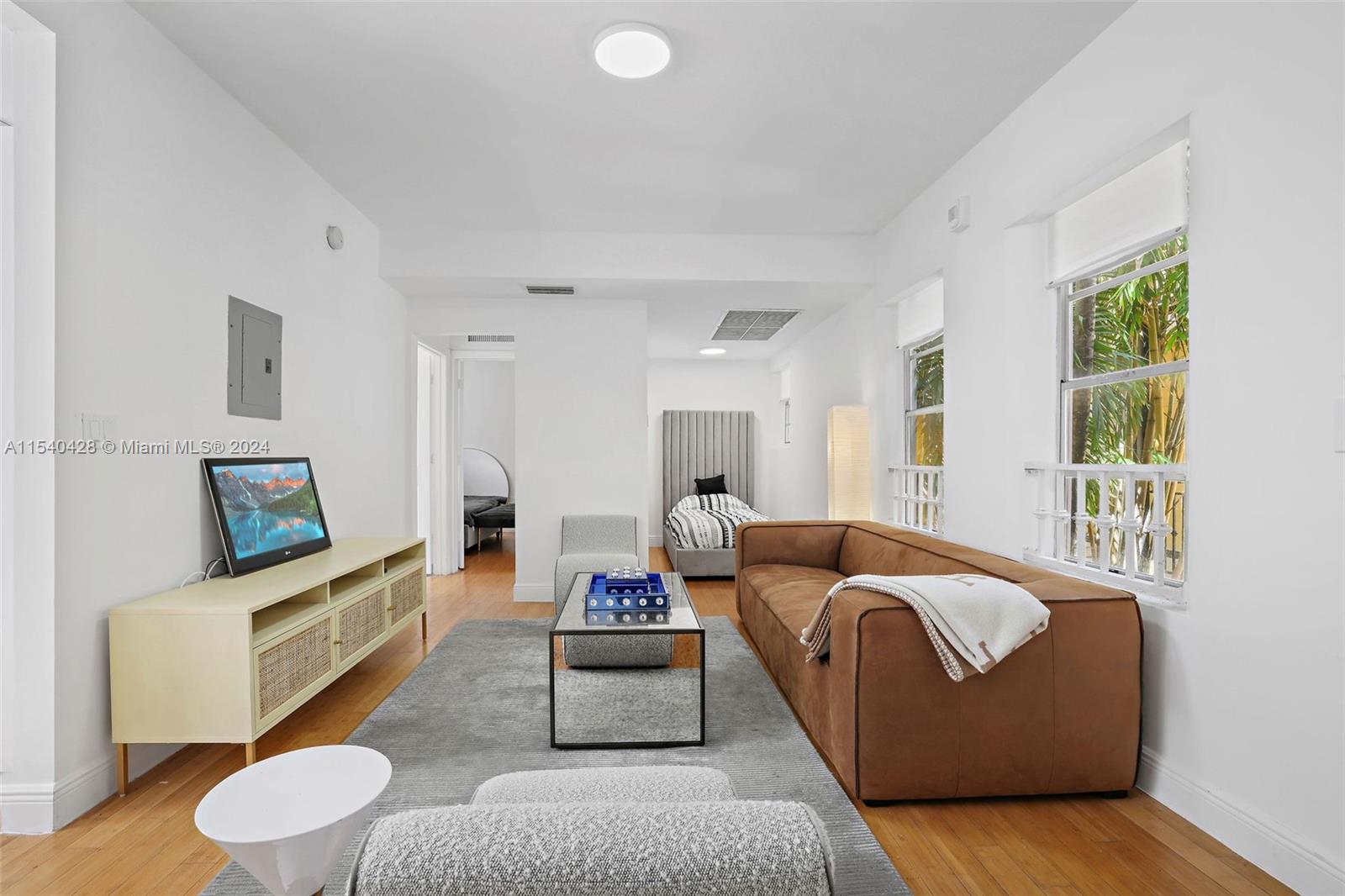 4812 Pine Tree Drive, Unit 207 Miami Beach, FL 33140 - Photo 3 of 23 a living room with furniture and a flat screen tv