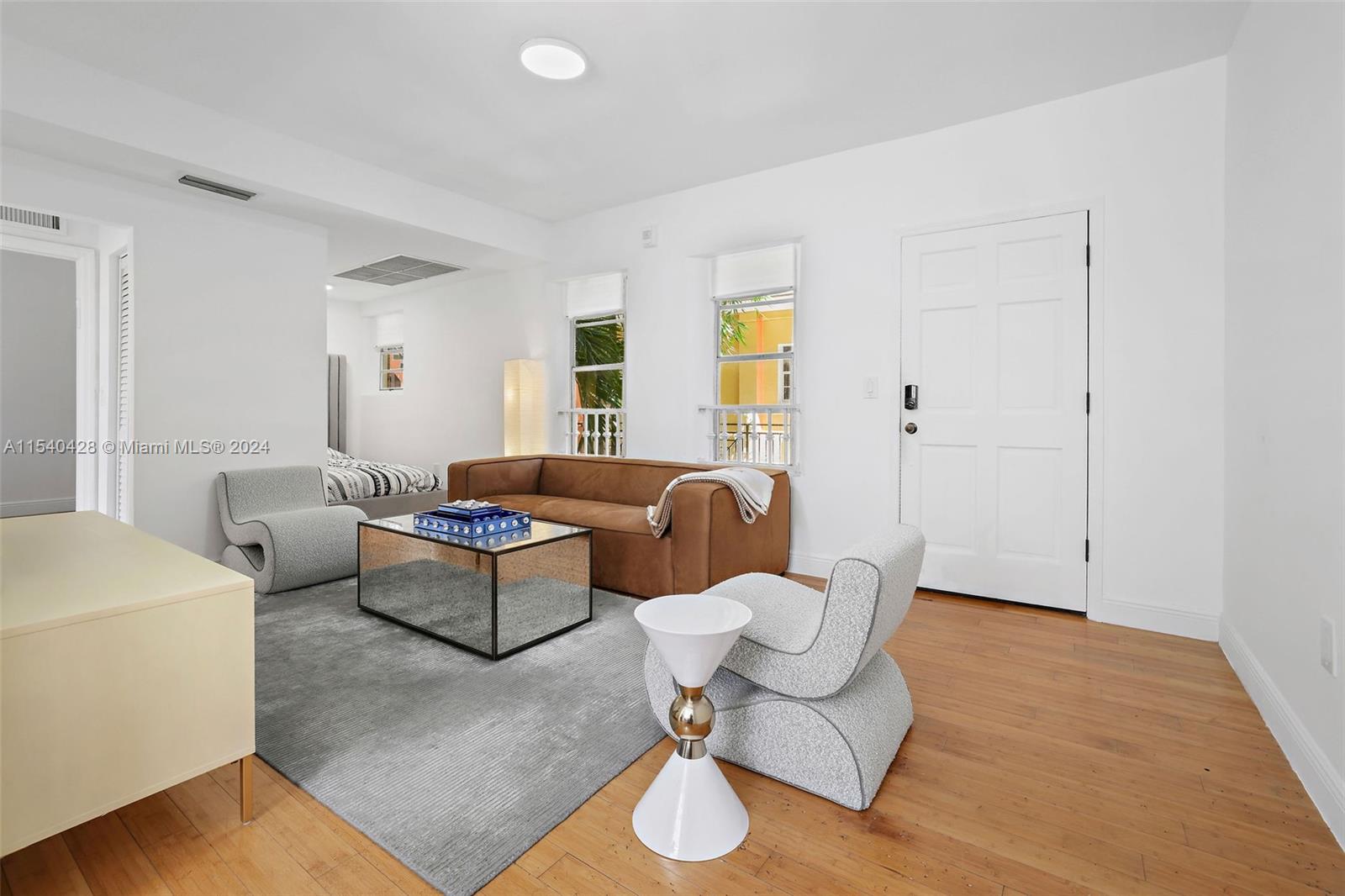 4812 Pine Tree Drive, Unit 207 Miami Beach, FL 33140 - Photo 8 of 23 a living room with furniture and wooden floor