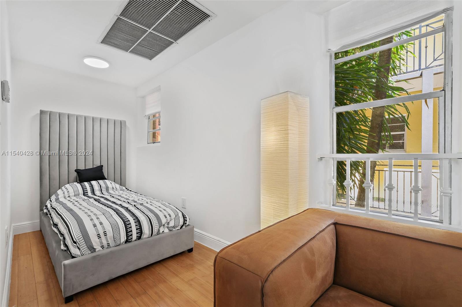 4812 Pine Tree Drive, Unit 207 Miami Beach, FL 33140 - Photo 9 of 23 a bedroom with furniture and windows