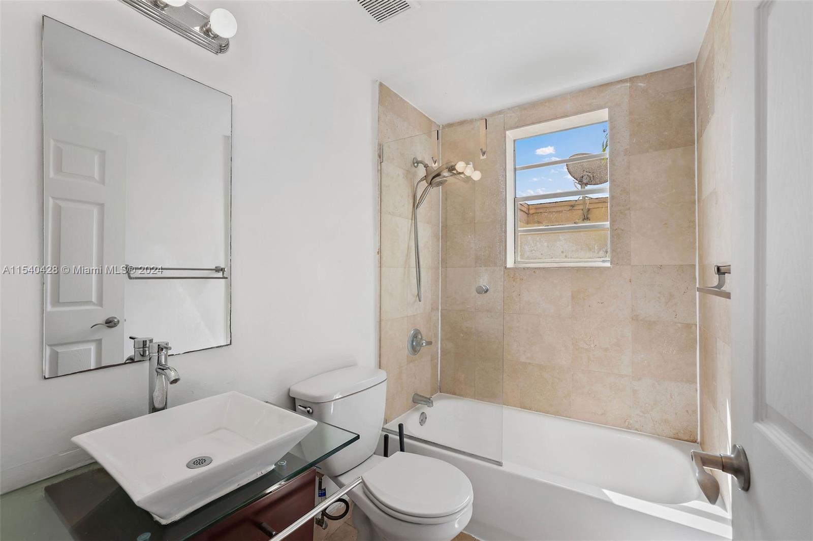 4812 Pine Tree Drive, Unit 207 Miami Beach, FL 33140 - Photo 10 of 23 a bathroom with a sink toilet and shower