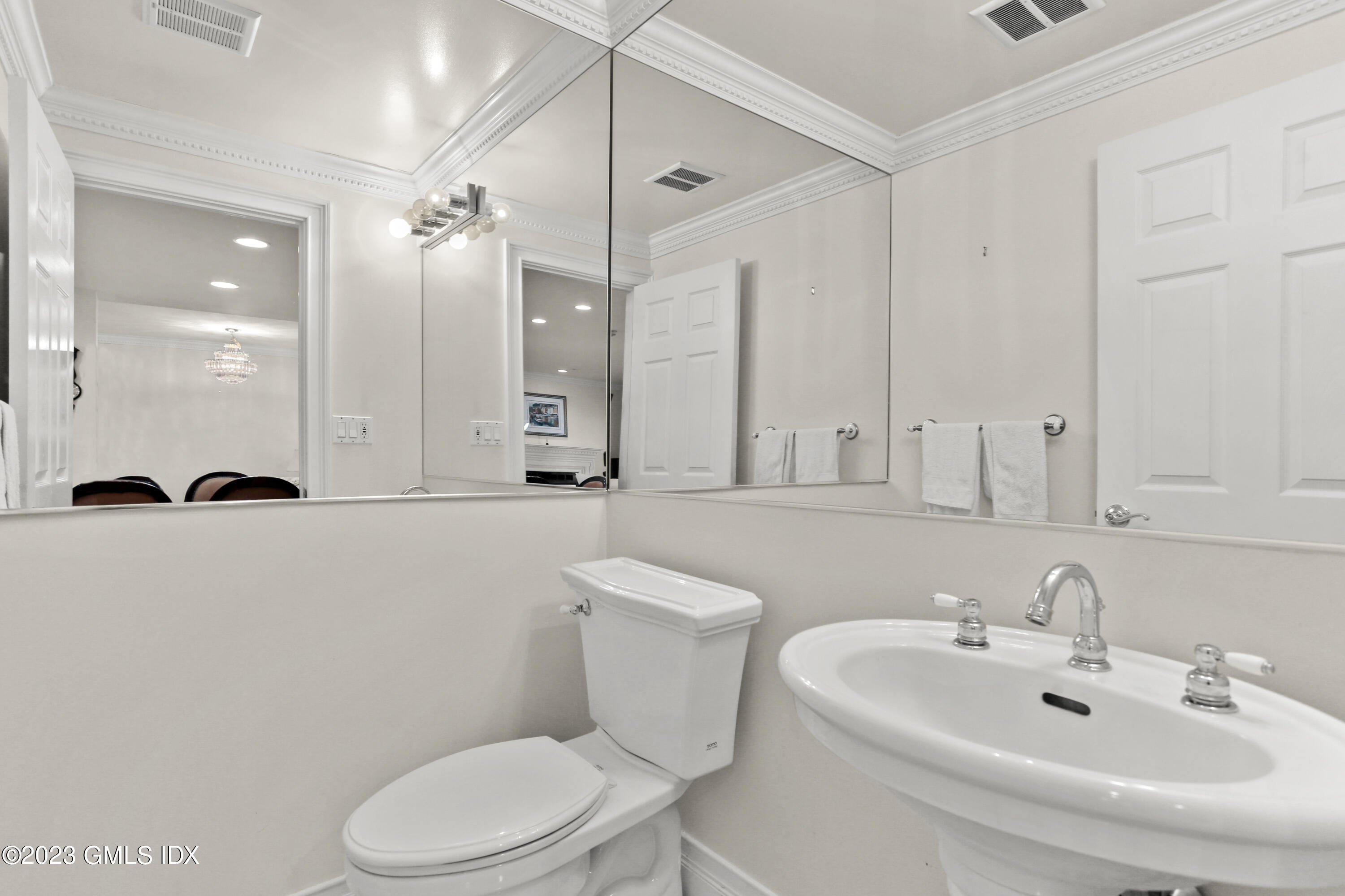 58 Sherwood Place Greenwich, CT 06830 - Photo 17 of 47 a bathroom with a sink a toilet and a large mirror