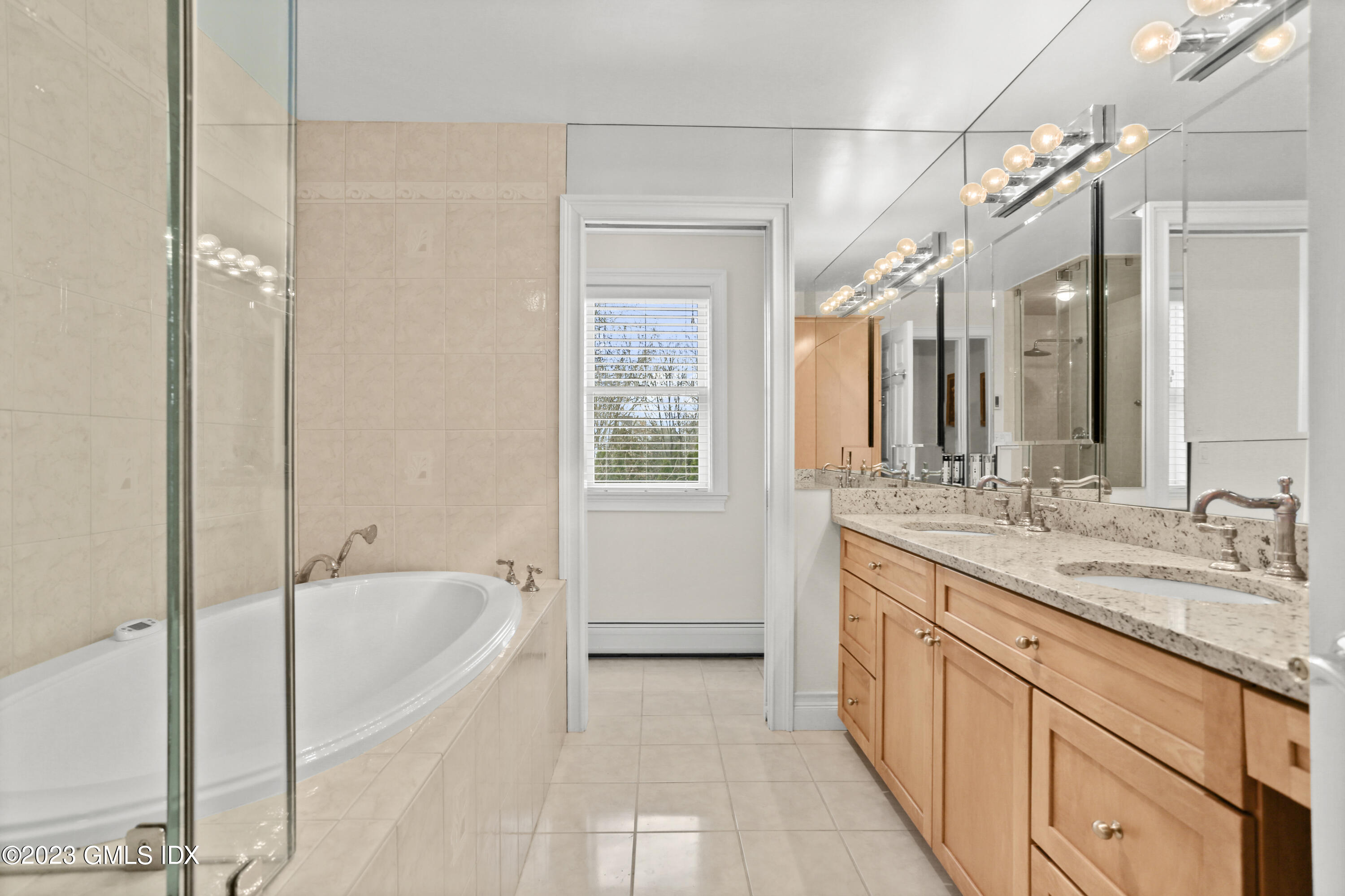 58 Sherwood Place Greenwich, CT 06830 - Photo 20 of 47 a spacious bathroom with a granite countertop tub sink shower and mirror