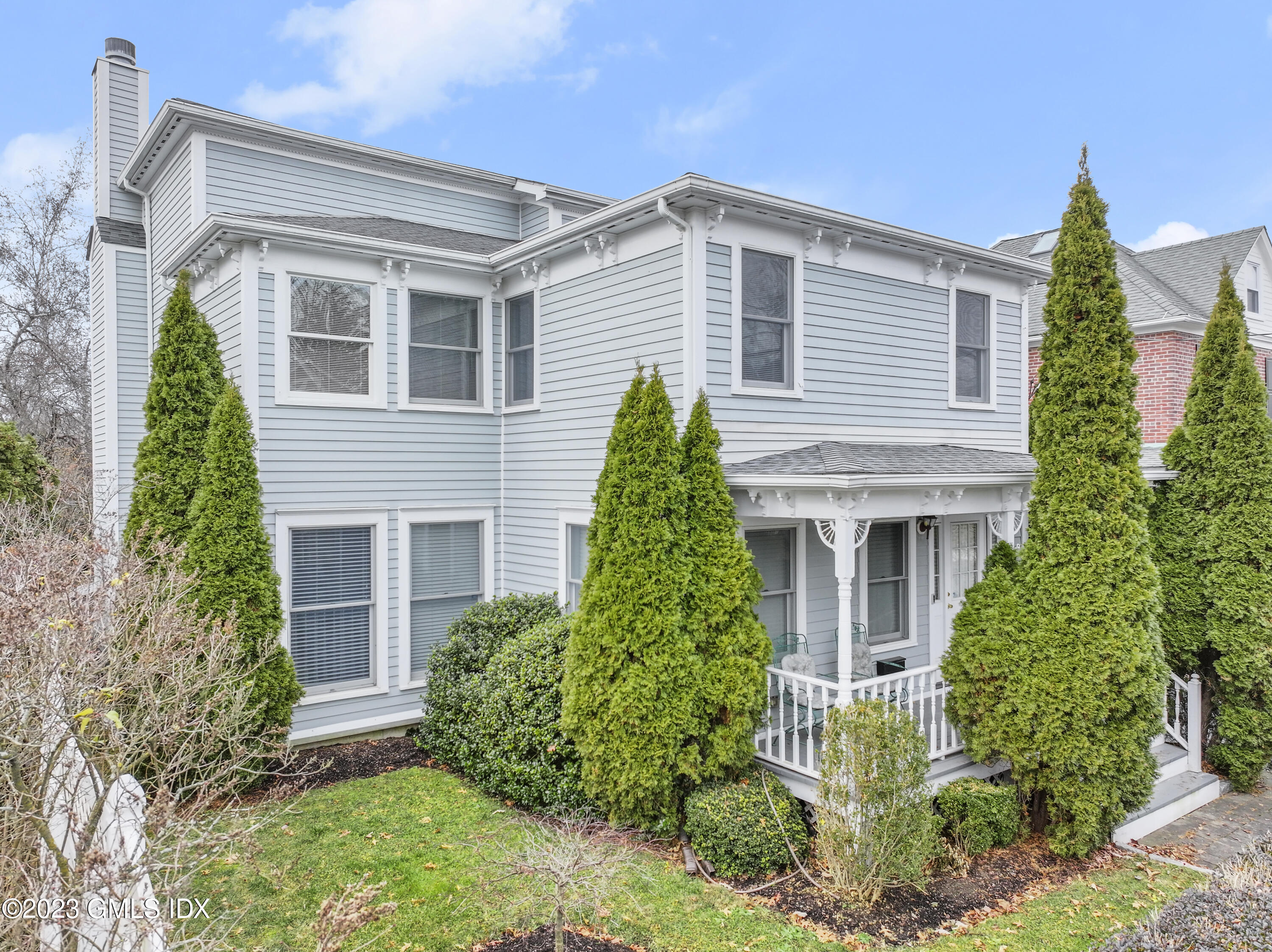 58 Sherwood Place Greenwich, CT 06830 - Photo 2 of 47 front view of a house with a yard