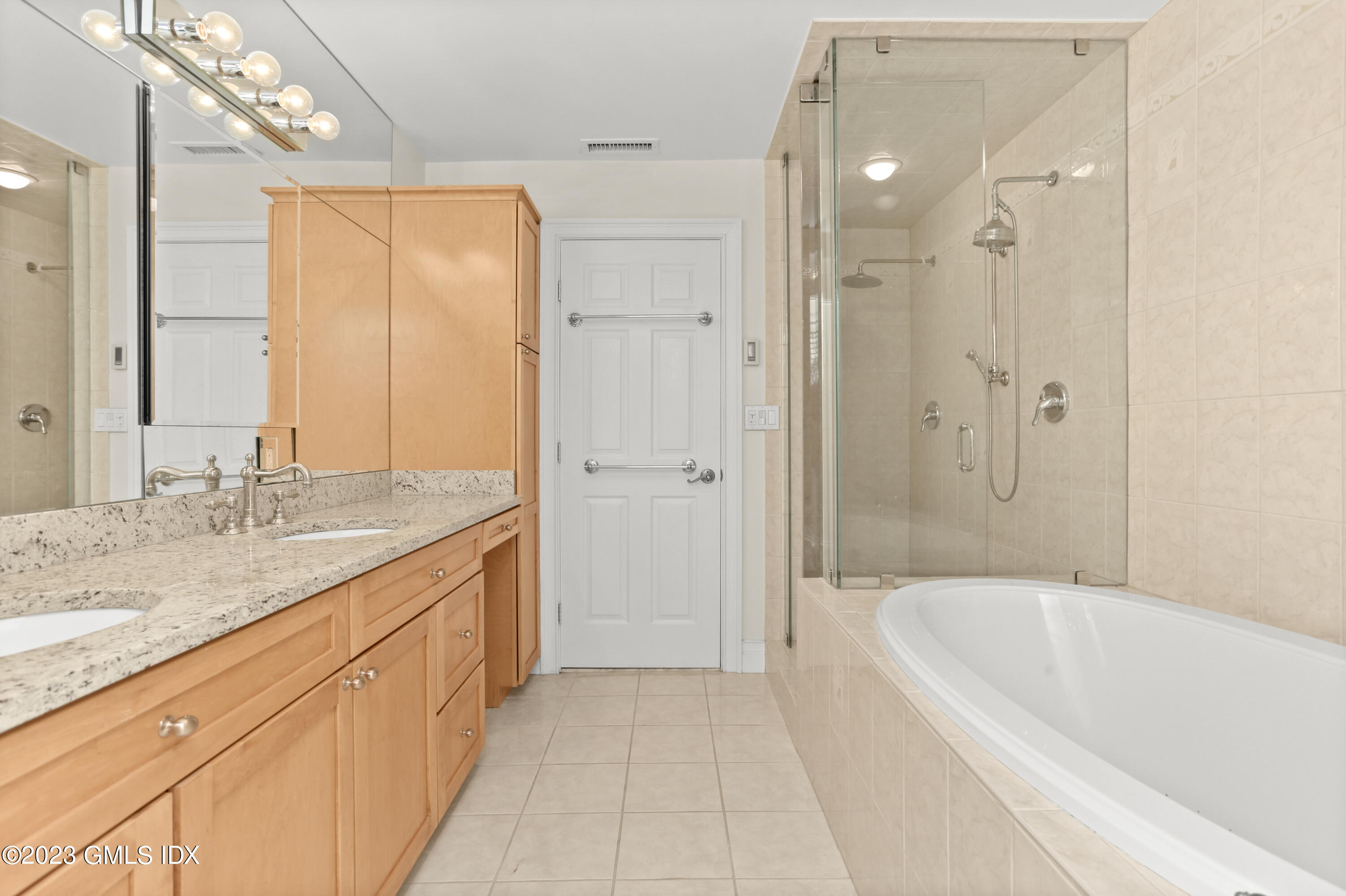 58 Sherwood Place Greenwich, CT 06830 - Photo 21 of 47 a spacious bathroom with a granite countertop tub sink shower and mirror