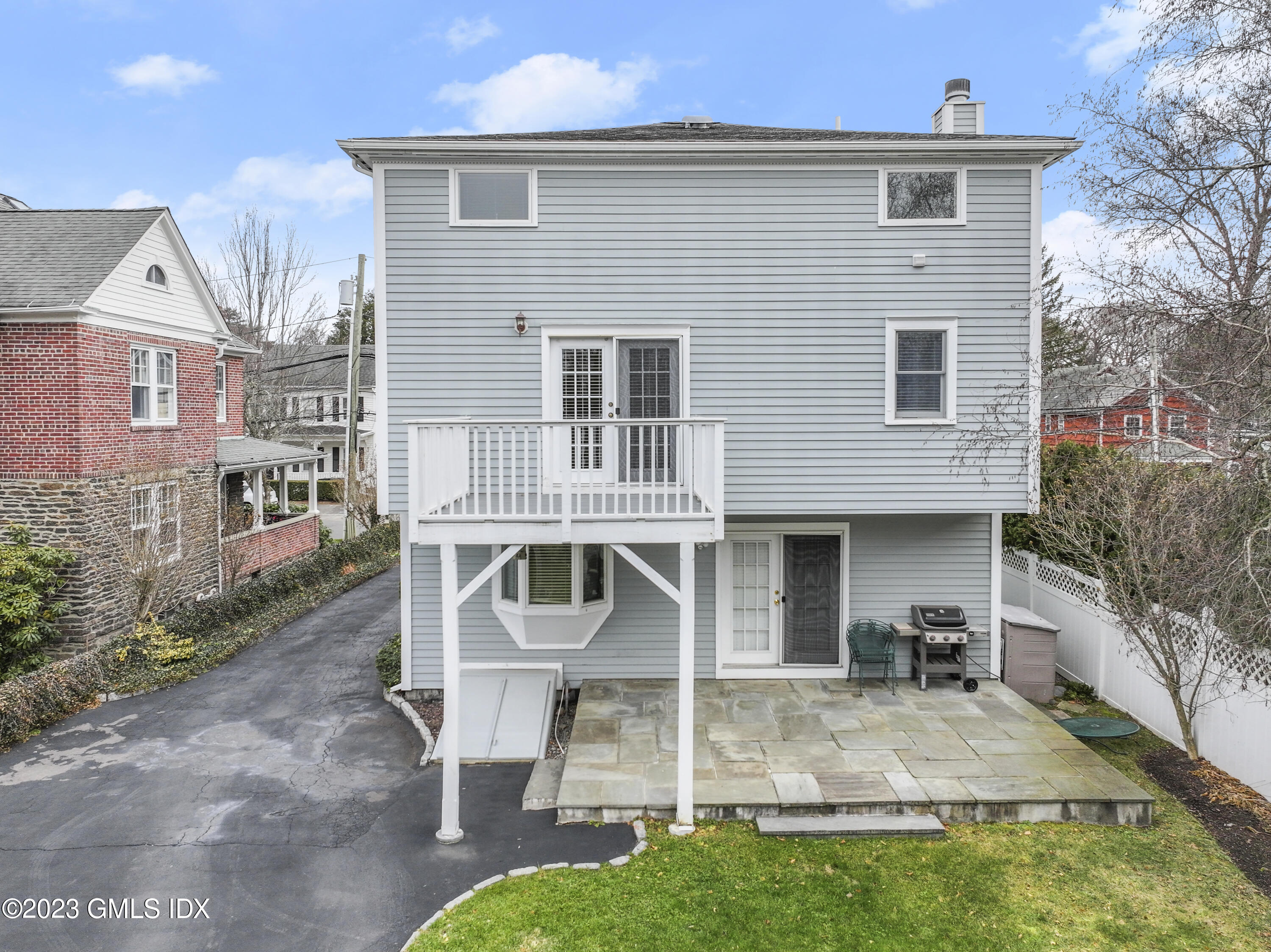 58 Sherwood Place Greenwich, CT 06830 - Photo 30 of 47 a front view of a house with a yard