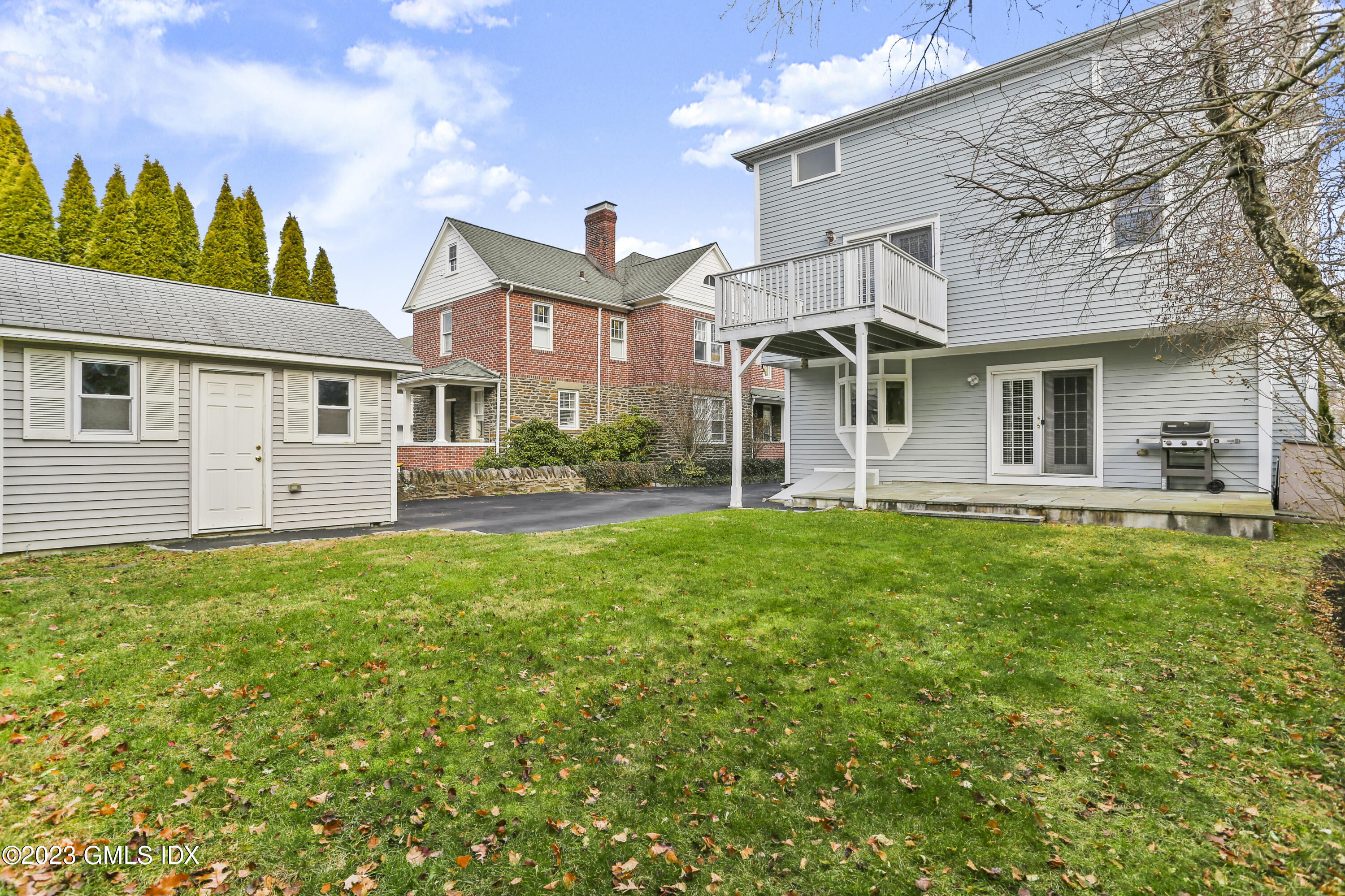 58 Sherwood Place Greenwich, CT 06830 - Photo 37 of 47 a front view of a house with a yard