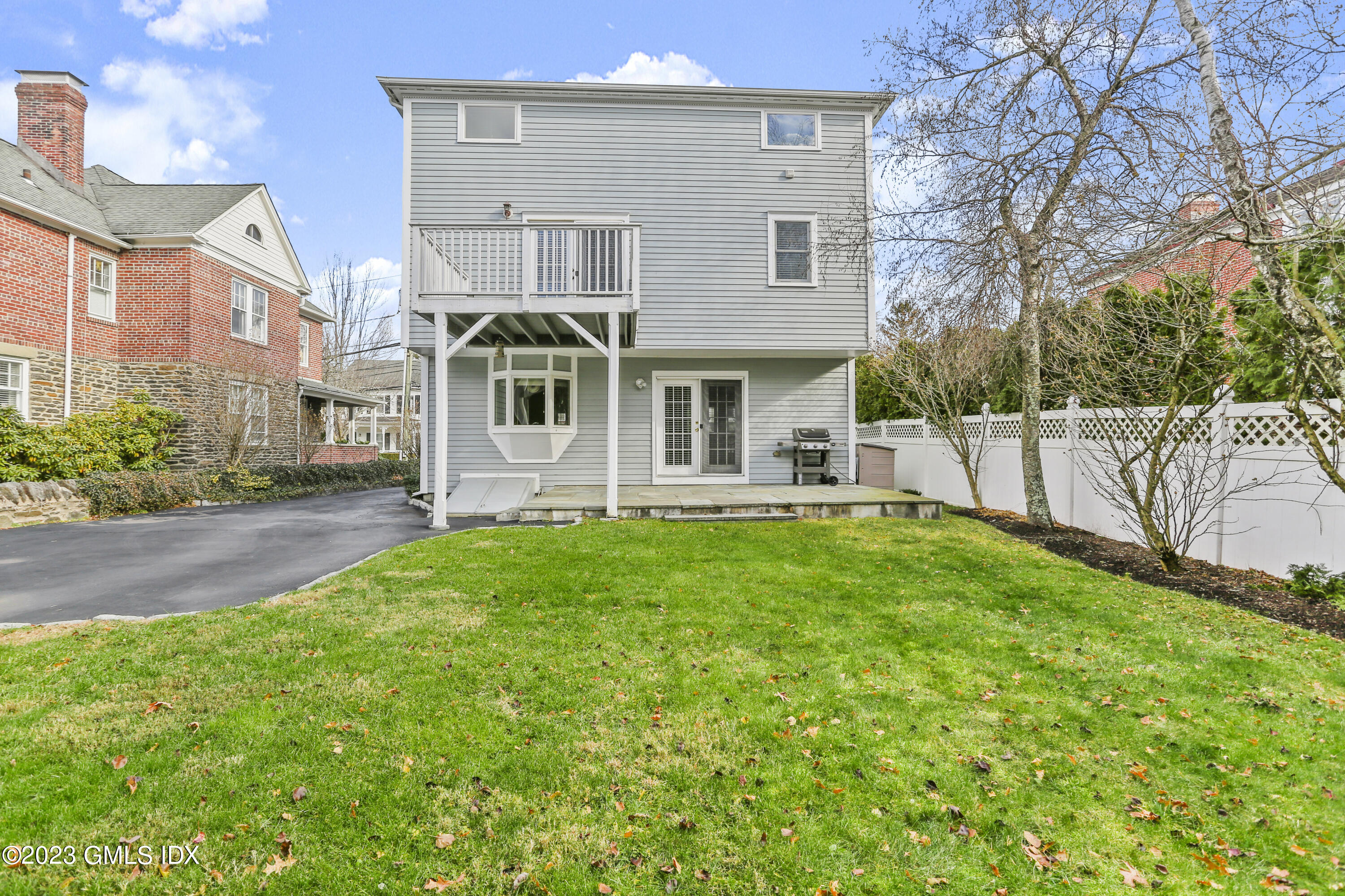 58 Sherwood Place Greenwich, CT 06830 - Photo 38 of 47 a front view of a house with a garden and plants