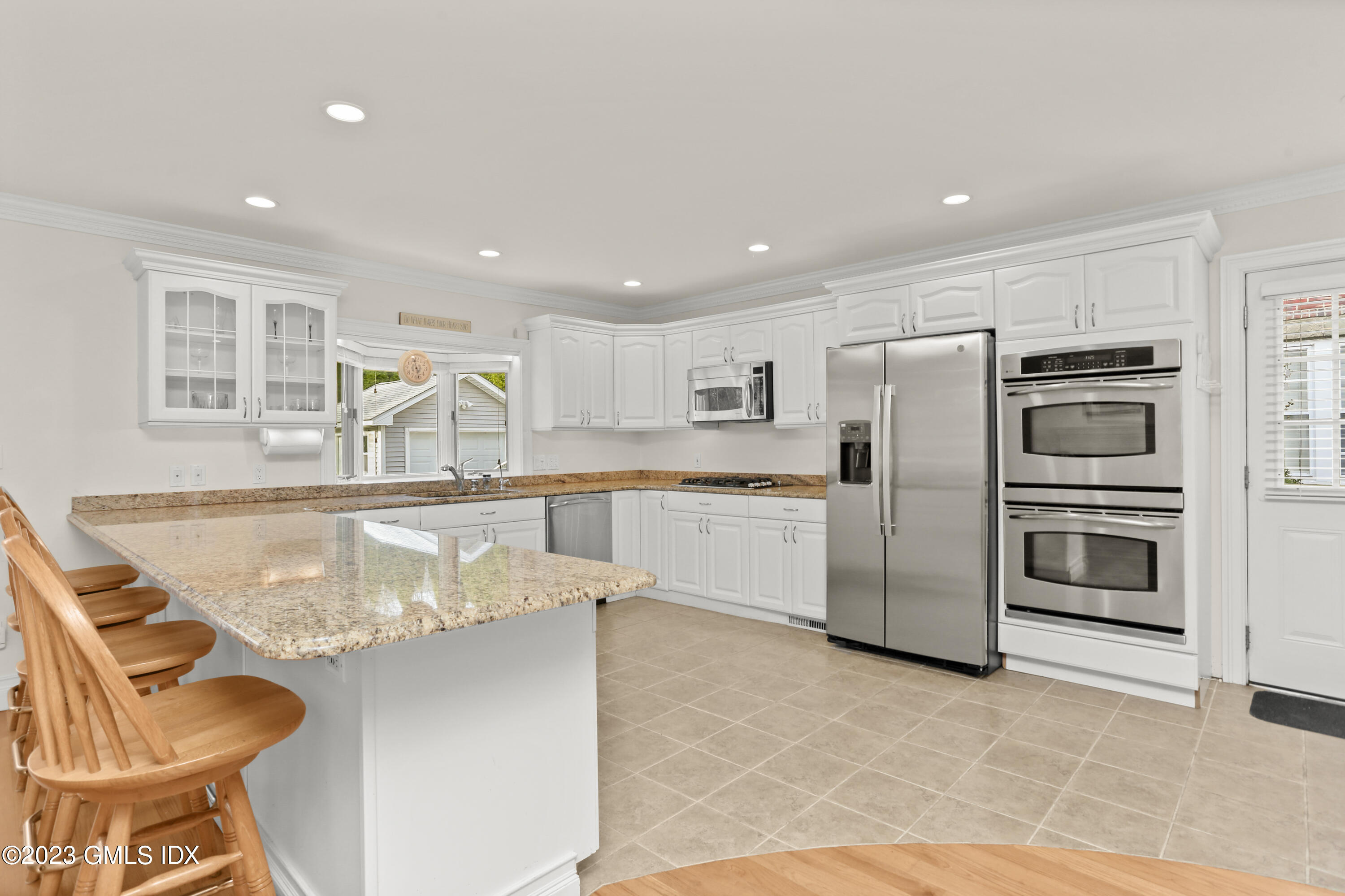 58 Sherwood Place Greenwich, CT 06830 - Photo 10 of 47 a kitchen with refrigerator cabinets and outdoor space