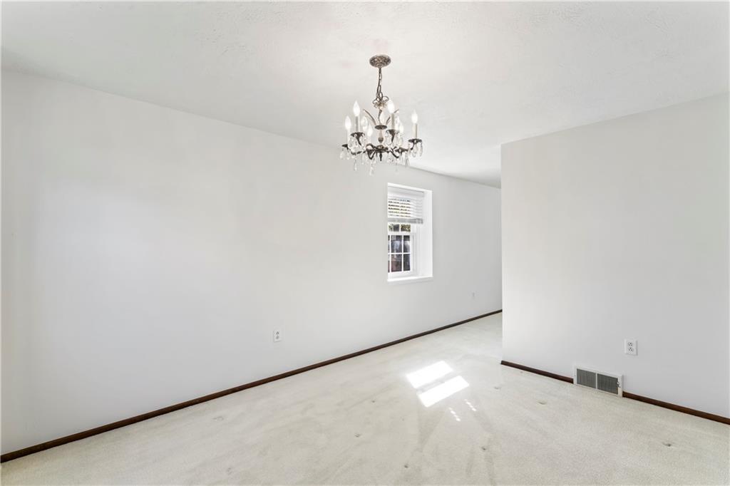 133 Tory Road Coraopolis, PA 15108 - Photo 19 of 48 an empty room with windows and chandelier