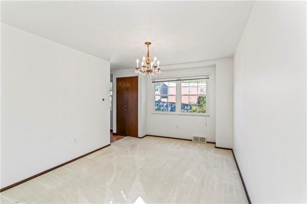 133 Tory Road Coraopolis, PA 15108 - Photo 21 of 48 an empty room with windows and chandelier