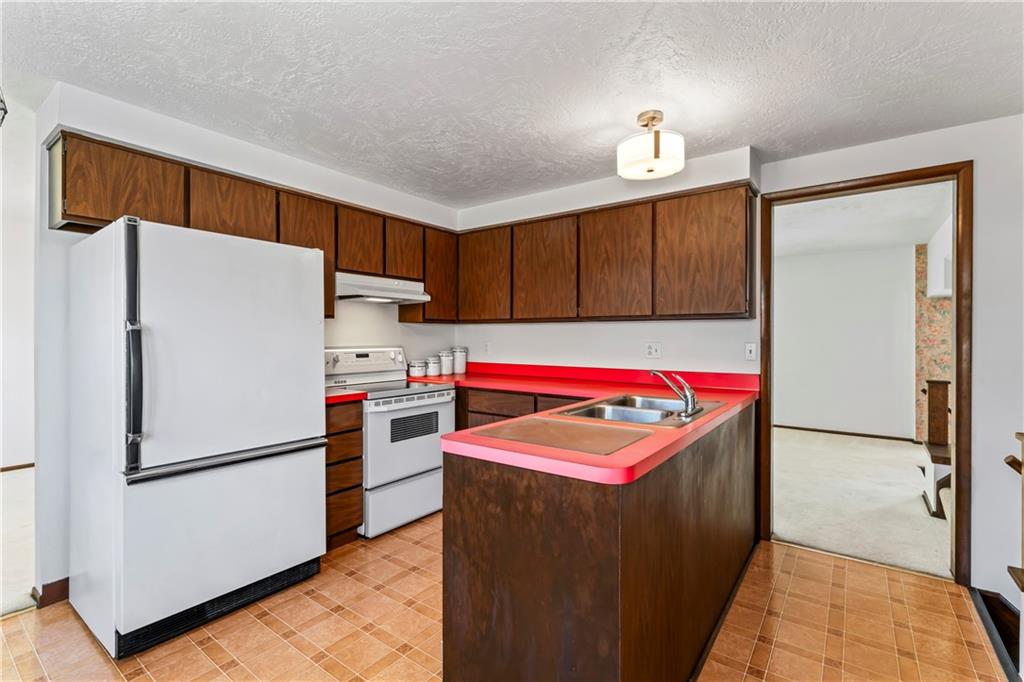 133 Tory Road Coraopolis, PA 15108 - Photo 23 of 48 a kitchen with refrigerator and cabinets