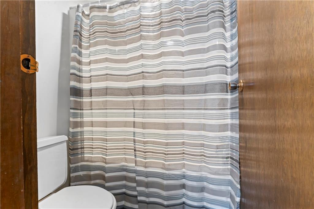 133 Tory Road Coraopolis, PA 15108 - Photo 36 of 48 a bathroom with a toilet and a shower curtain