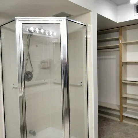 a bathroom with a glass shower door