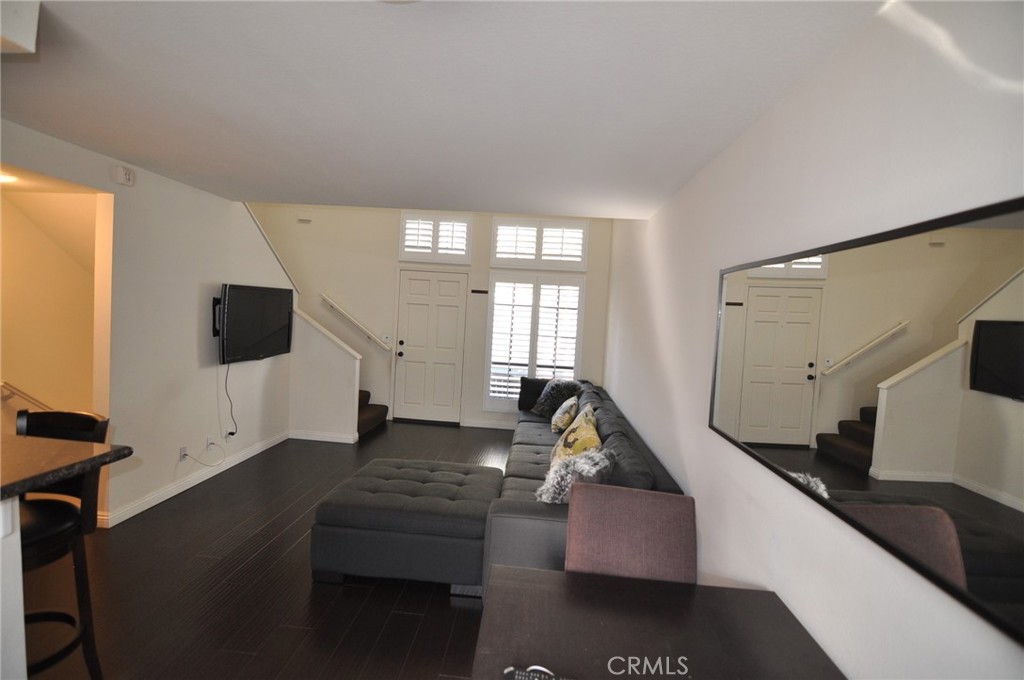 249 Alpine Street, Unit 48 Pasadena, CA 91106 - Photo 3 of 14 a living room with furniture and a flat screen tv