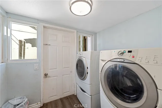 a utility room with sink dryer and washer