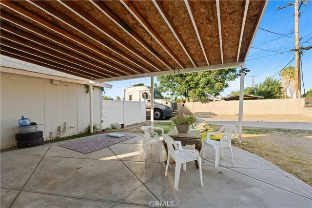 a view of a patio with table and chairs and potted plants