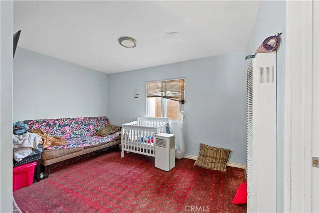a bedroom with furniture and a window