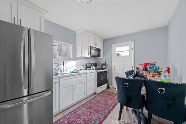 a kitchen with granite countertop a refrigerator and a sink