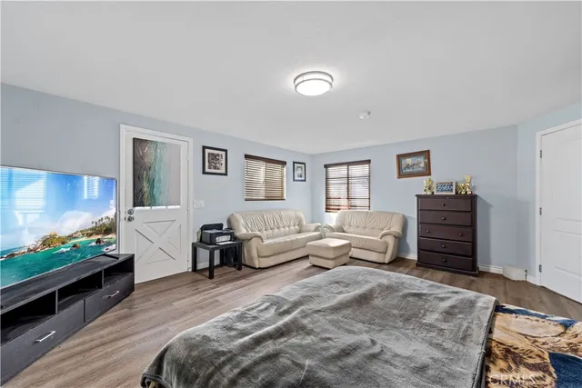 a bedroom with furniture and a flat screen tv