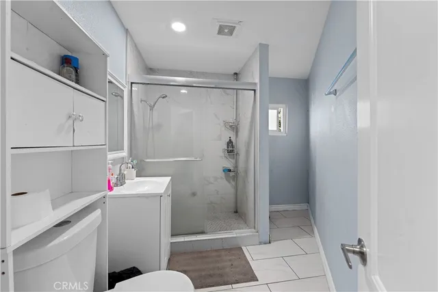 a bathroom with a shower a sink a toilet and shower