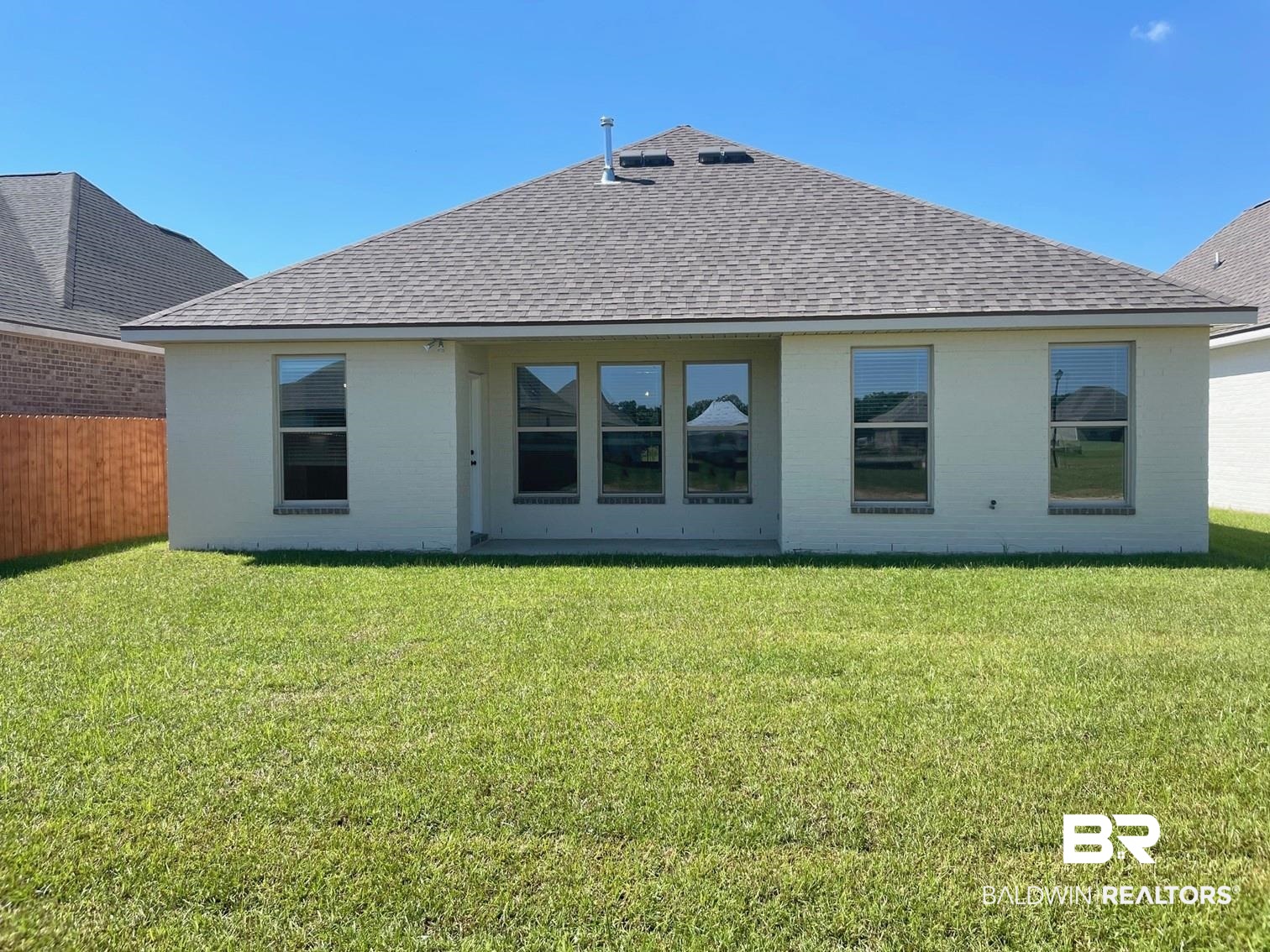 1565 Fenton Circle Foley, AL 36535 - Photo 13 of 15 Rear view of house with a lawn