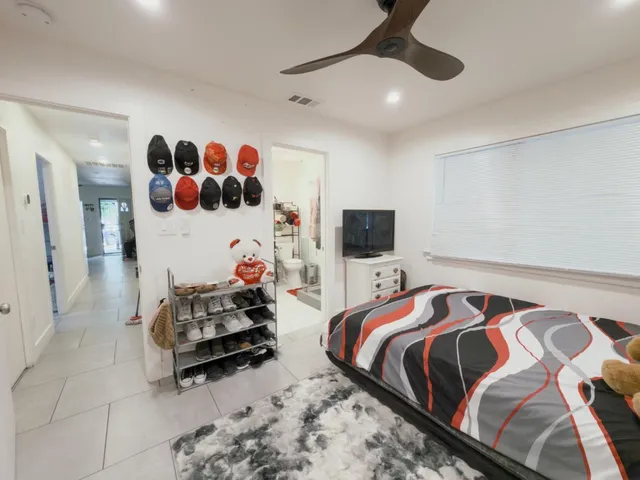 a bedroom with a bed and a tv