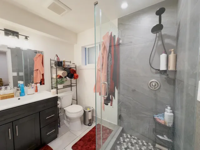 a spacious bathroom with a shower sink and toilet
