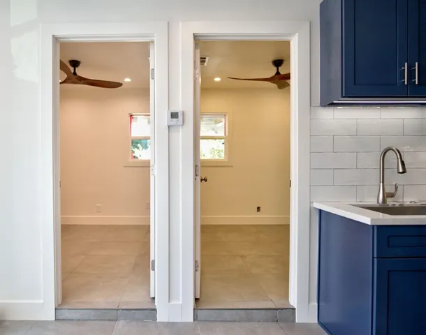 a bathroom with a granite countertop sink mirror and shower
