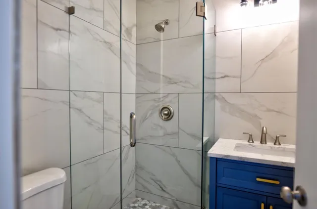 a bathroom with a sink vanity and toilet