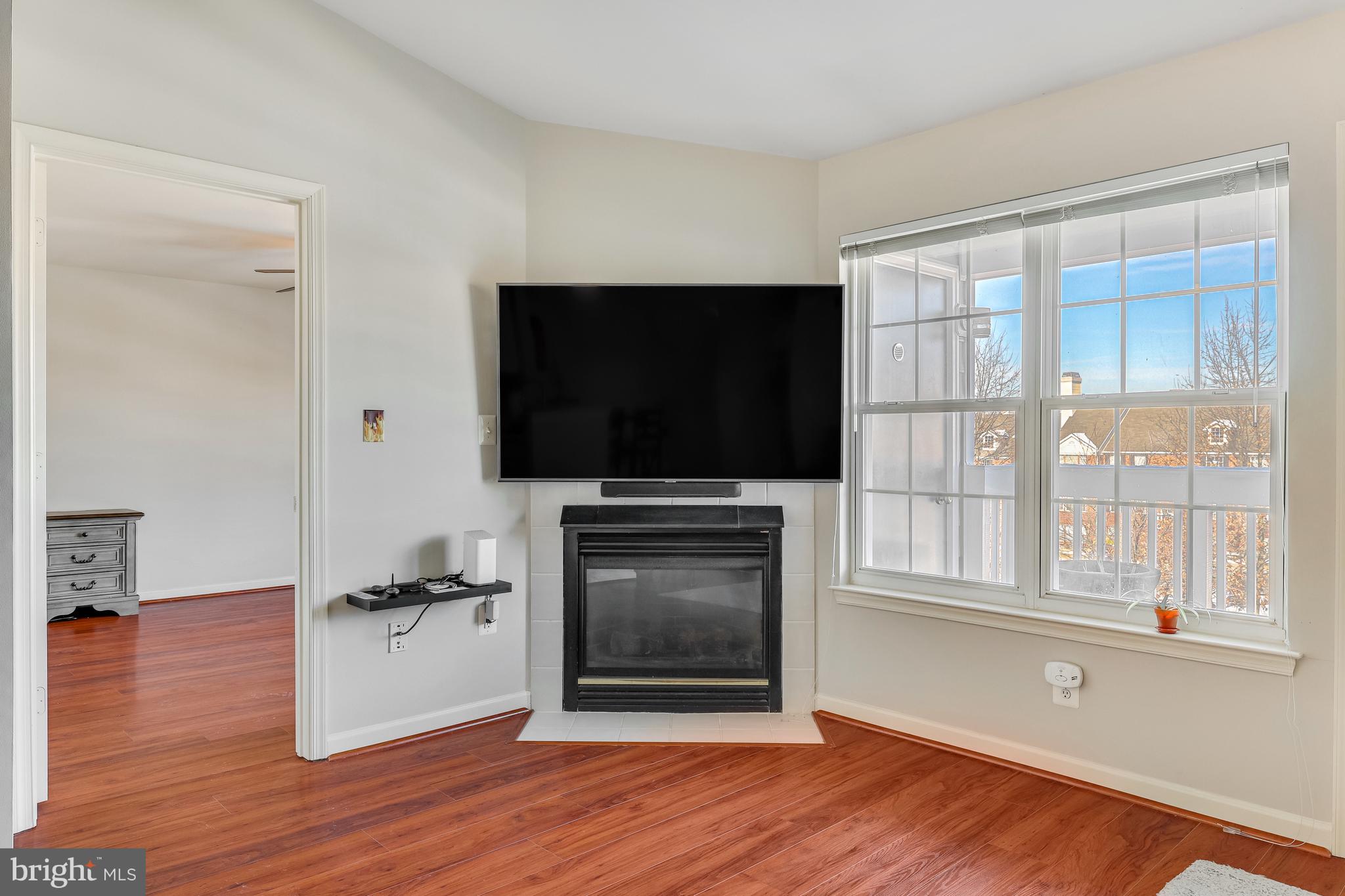 521 Constellation Square Southeast, Unit J Leesburg, VA 20175 - Photo 11 of 37 a living room with flat screen tv and a window