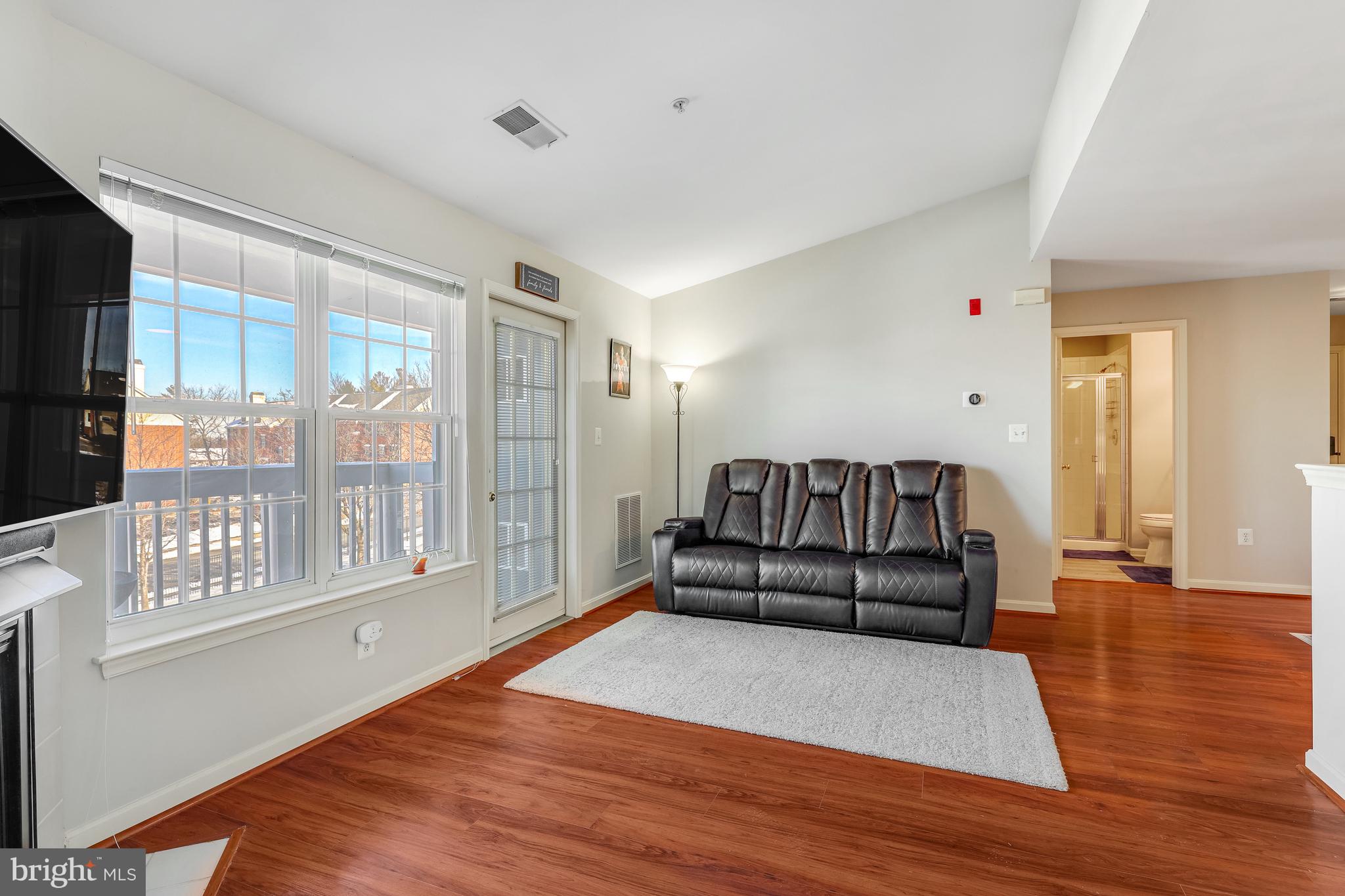 521 Constellation Square Southeast, Unit J Leesburg, VA 20175 - Photo 12 of 37 a living room with furniture and wooden floor
