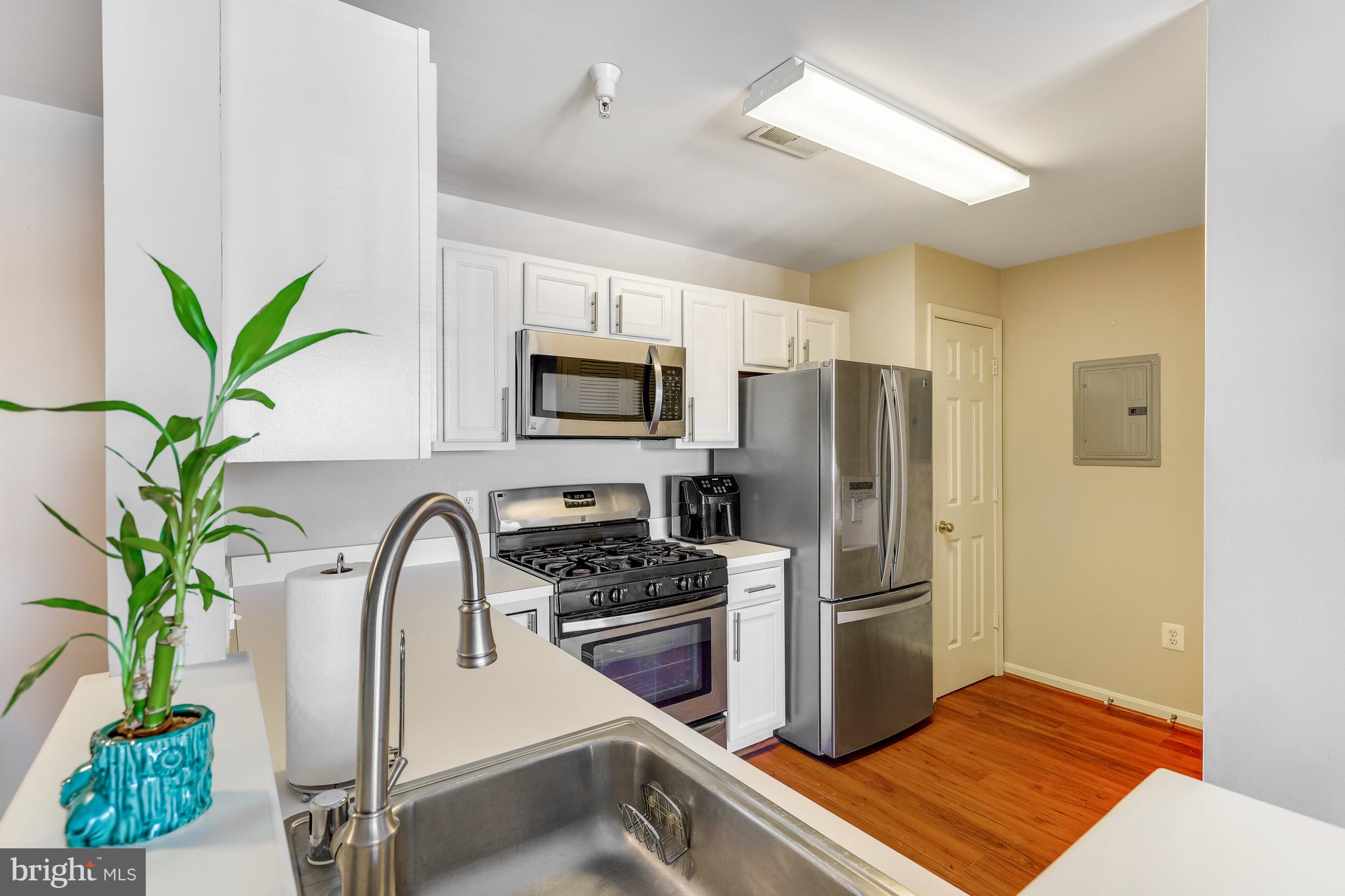 521 Constellation Square Southeast, Unit J Leesburg, VA 20175 - Photo 13 of 37 a kitchen with stainless steel appliances a refrigerator sink and stove