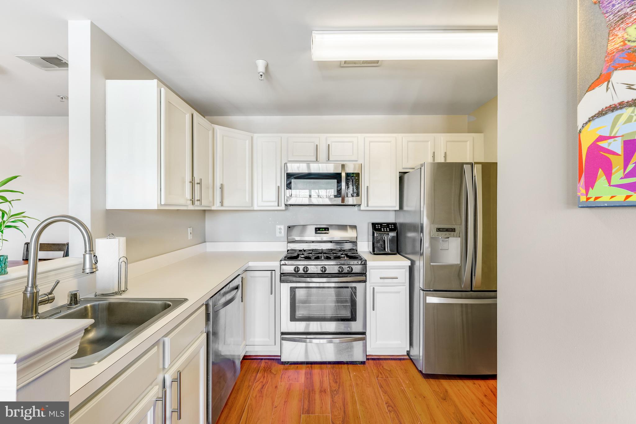 521 Constellation Square Southeast, Unit J Leesburg, VA 20175 - Photo 14 of 37 a kitchen with stainless steel appliances a refrigerator stove and sink