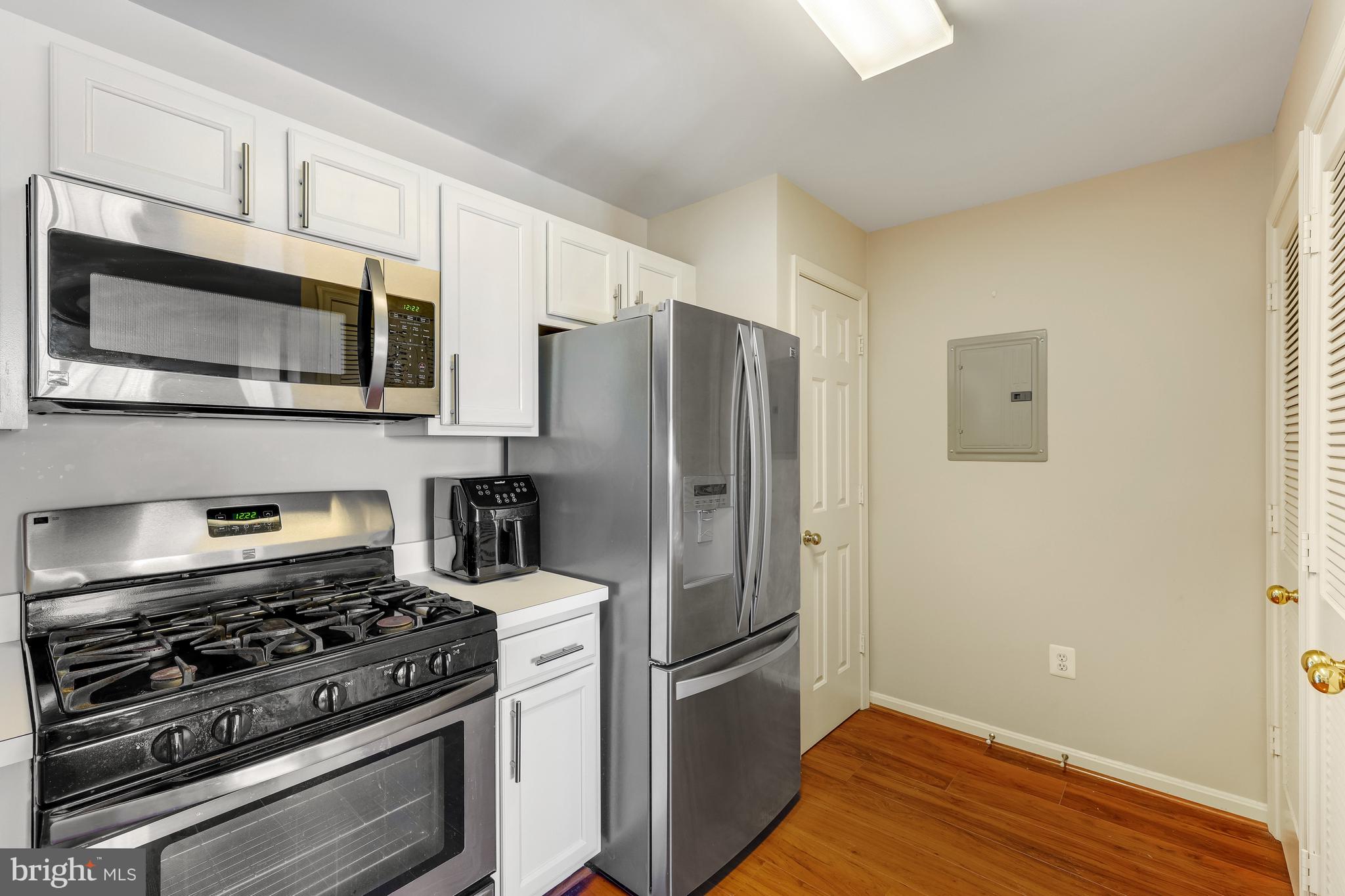 521 Constellation Square Southeast, Unit J Leesburg, VA 20175 - Photo 15 of 37 a kitchen with stainless steel appliances a stove a microwave and a refrigerator