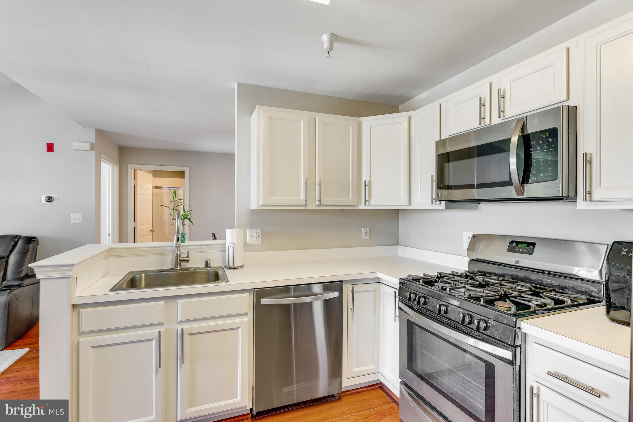 521 Constellation Square Southeast, Unit J Leesburg, VA 20175 - Photo 16 of 37 a kitchen with stainless steel appliances granite countertop a sink stove oven a sink and dishwasher with cabinets
