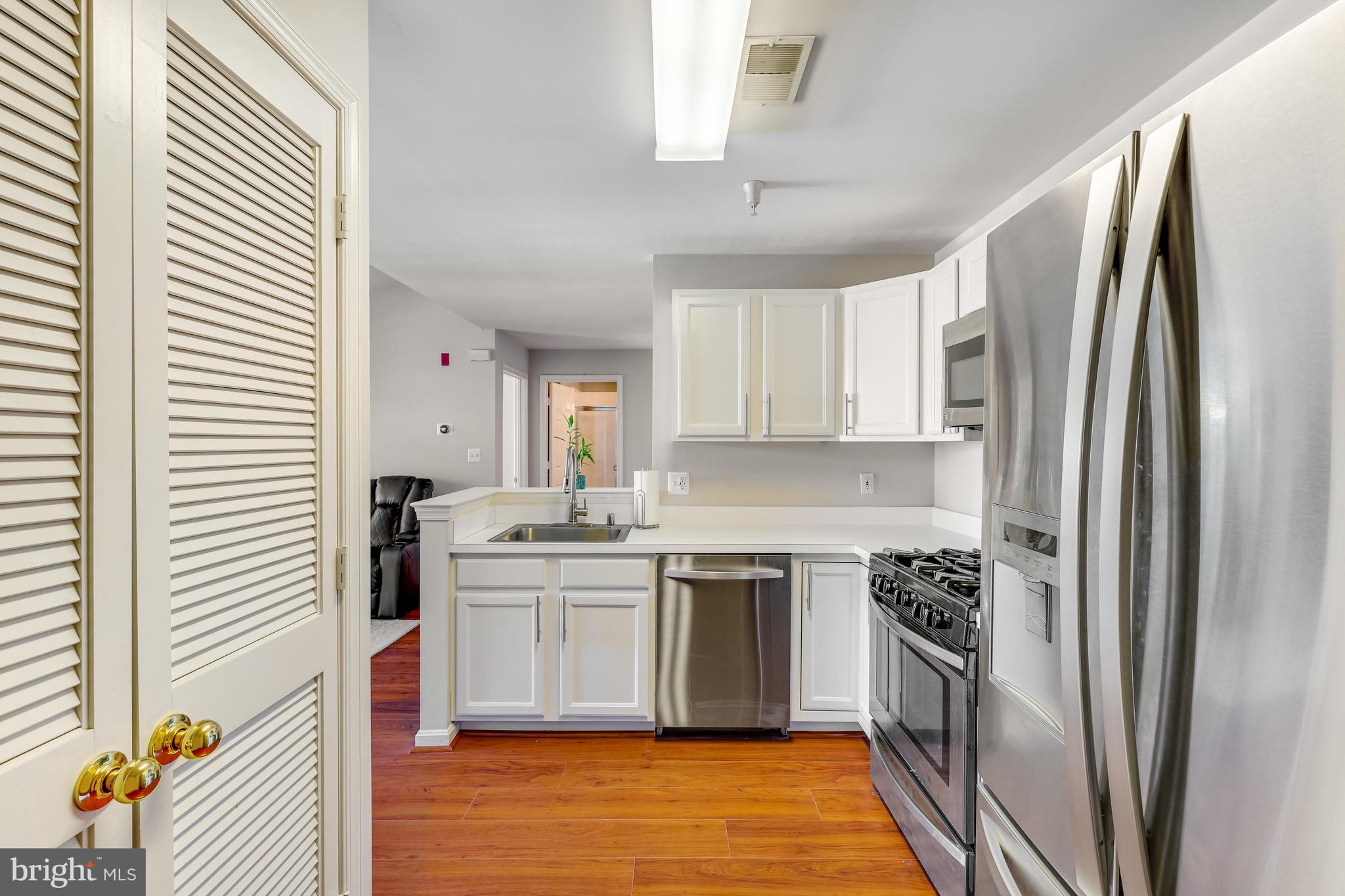 521 Constellation Square Southeast, Unit J Leesburg, VA 20175 - Photo 17 of 37 a kitchen with a sink cabinets stainless steel appliances and a window