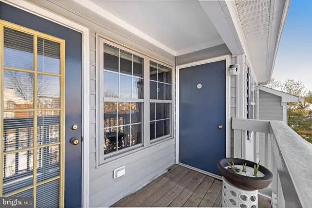 a view of a balcony with chair and wooden floor