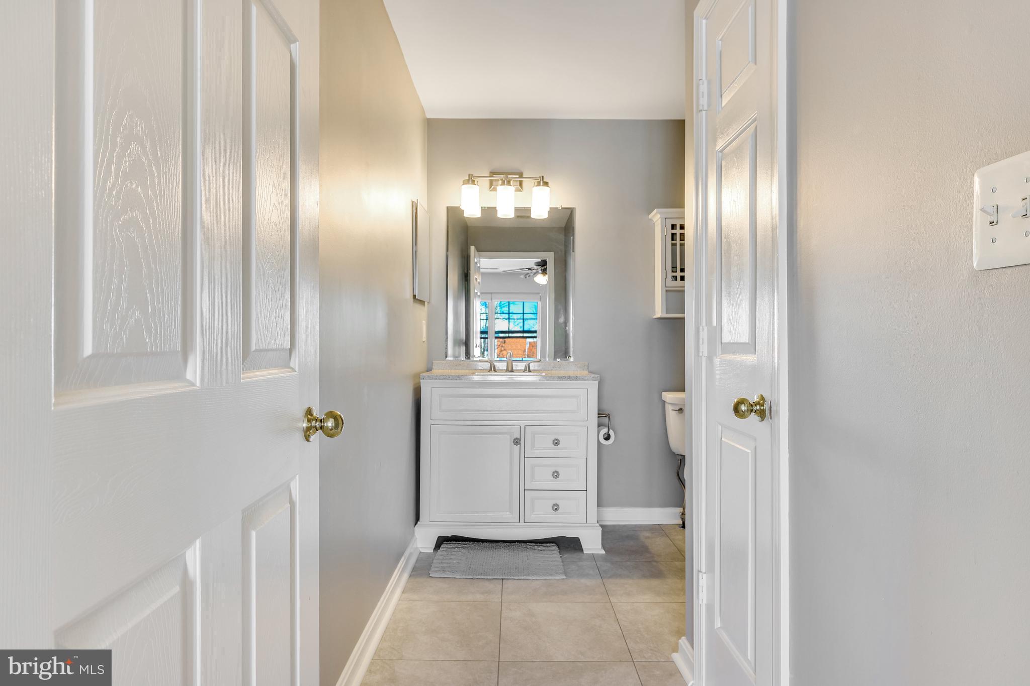 521 Constellation Square Southeast, Unit J Leesburg, VA 20175 - Photo 23 of 37 a bathroom with a sink and a mirror