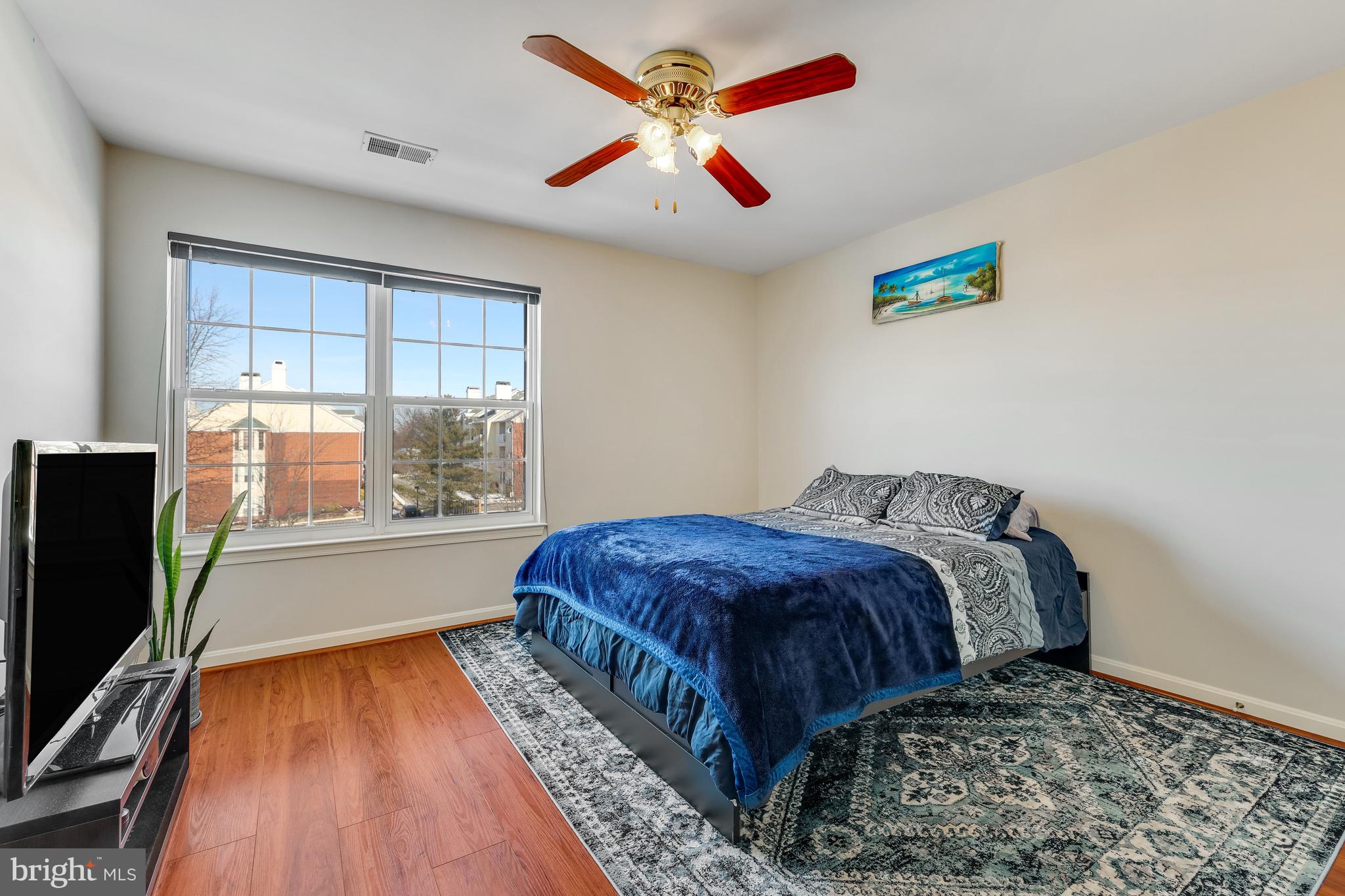 521 Constellation Square Southeast, Unit J Leesburg, VA 20175 - Photo 26 of 37 a bed sitting in a bedroom next to a window