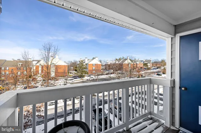 a view of a balcony with chair and wooden floor