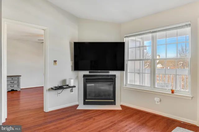 a living room with flat screen tv and a window