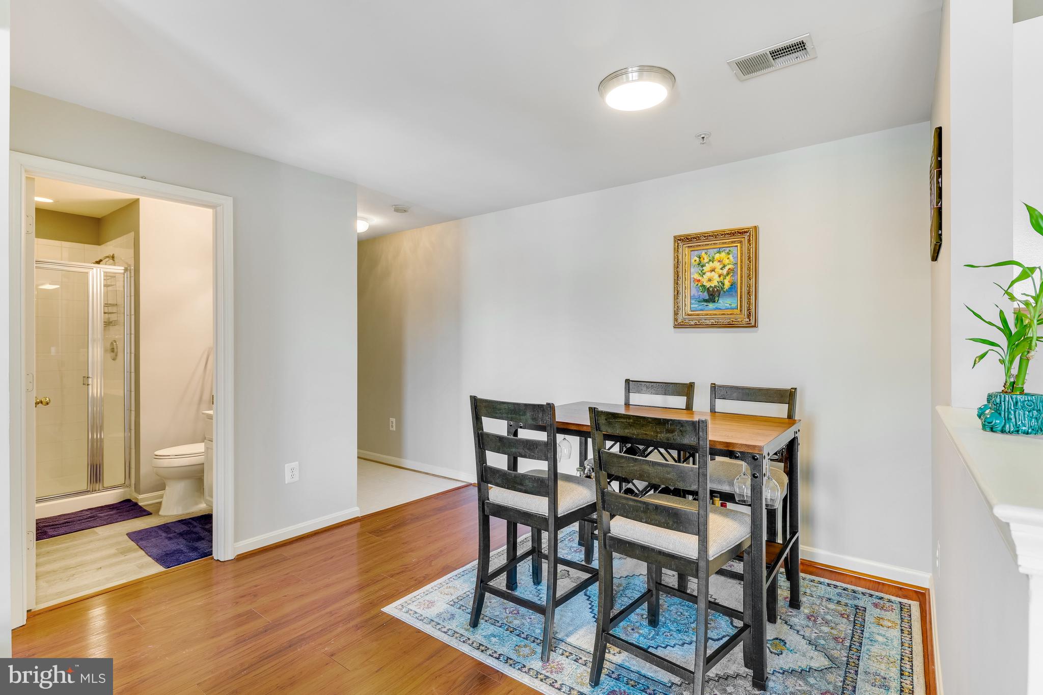 521 Constellation Square Southeast, Unit J Leesburg, VA 20175 - Photo 8 of 37 a view of a dining room with furniture and wooden floor